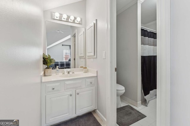 full bathroom featuring toilet, connected bathroom, vanity, baseboards, and tile patterned floors