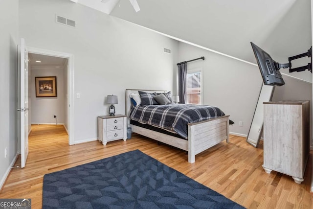 bedroom with light wood-style flooring, visible vents, and baseboards