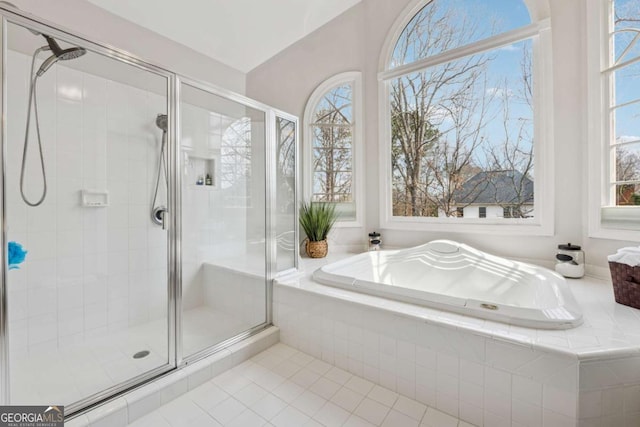 bathroom with tile patterned floors, a shower stall, and a bath