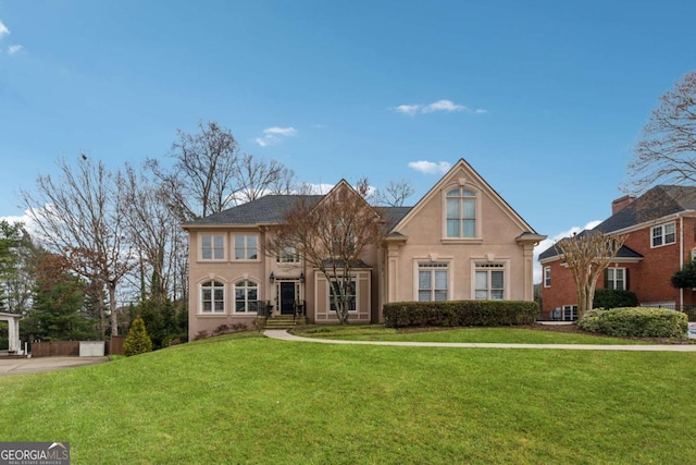 view of front of house featuring a front lawn and stucco siding