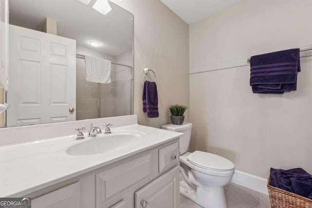 full bathroom featuring toilet, a tile shower, vanity, tile patterned flooring, and baseboards