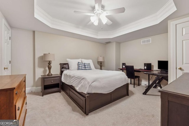 bedroom featuring baseboards, visible vents, a raised ceiling, light colored carpet, and ornamental molding