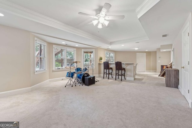 unfurnished room with carpet, visible vents, a raised ceiling, and crown molding