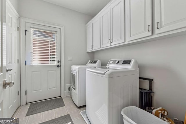 clothes washing area featuring cabinet space, washer and clothes dryer, and light tile patterned flooring