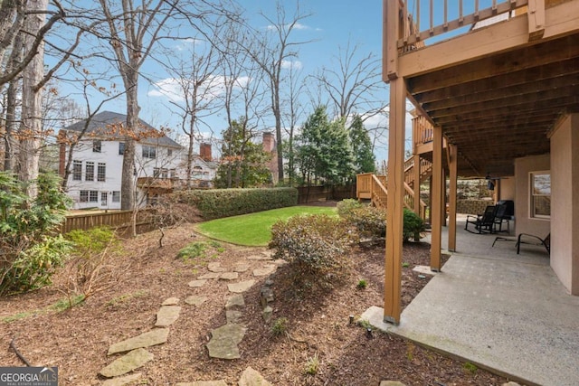 view of yard with stairs, a patio area, and fence