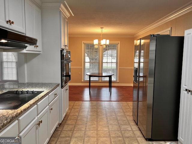 kitchen with a chandelier, crown molding, under cabinet range hood, decorative light fixtures, and black appliances