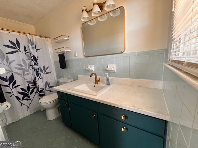 full bath with a wainscoted wall, a shower with shower curtain, toilet, vanity, and tile walls