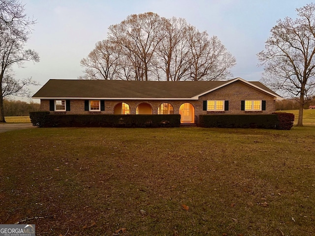 single story home featuring a front lawn and brick siding