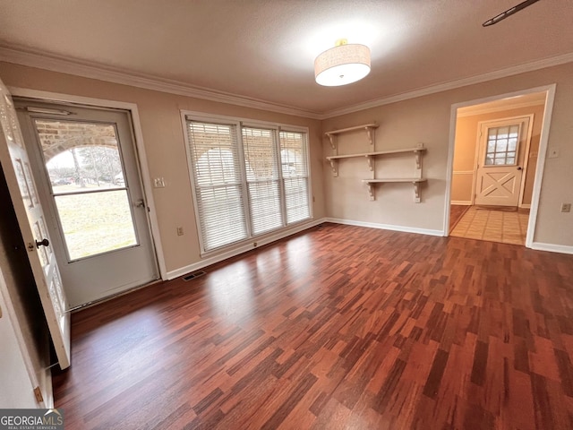 entryway with baseboards, dark wood finished floors, visible vents, and crown molding