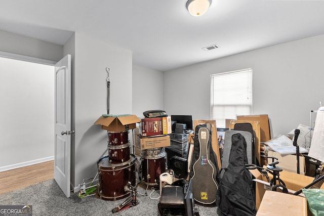 misc room with baseboards and visible vents