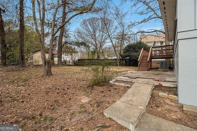 view of yard with stairway, a patio area, fence, cooling unit, and a wooden deck