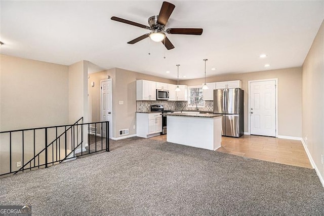 kitchen featuring white cabinetry, visible vents, appliances with stainless steel finishes, and decorative backsplash