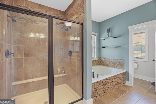 full bathroom with a shower stall, baseboards, a bath, and tile patterned floors