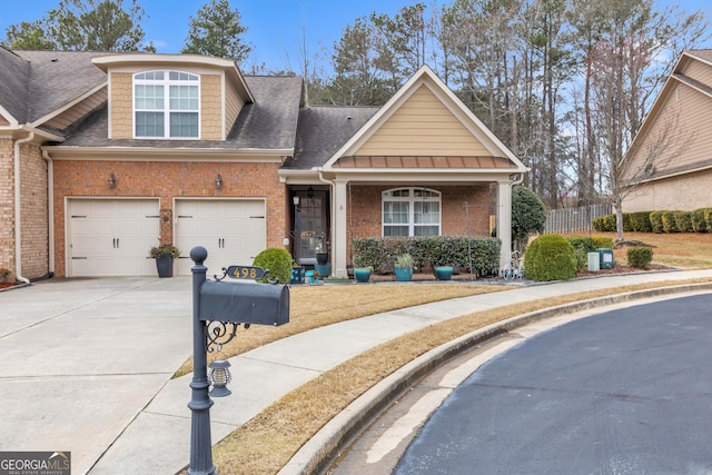 view of front facade featuring brick siding, a shingled roof, concrete driveway, fence, and a garage