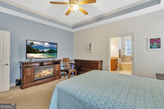 bedroom with a glass covered fireplace, carpet flooring, baseboards, ensuite bath, and crown molding