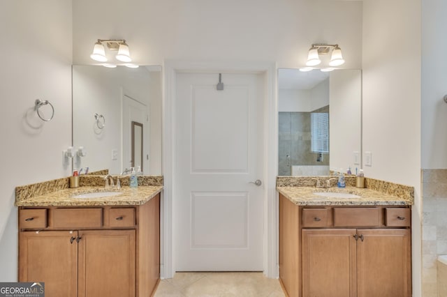 full bath featuring two vanities, a sink, and tile patterned floors