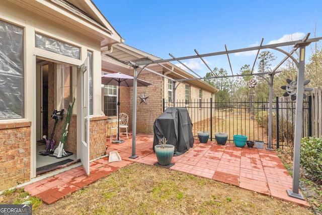 view of patio featuring grilling area and fence