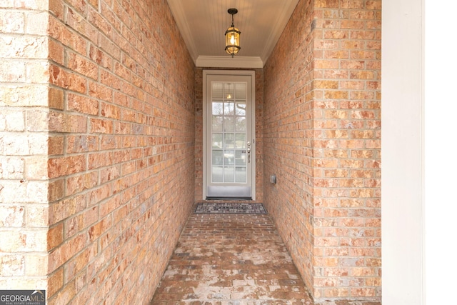 entrance to property featuring brick siding