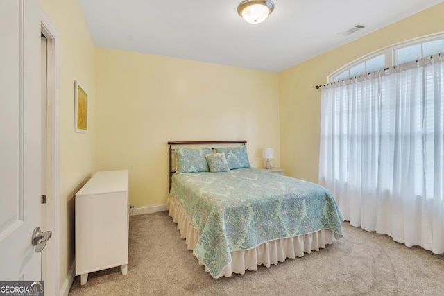 bedroom featuring light carpet and visible vents