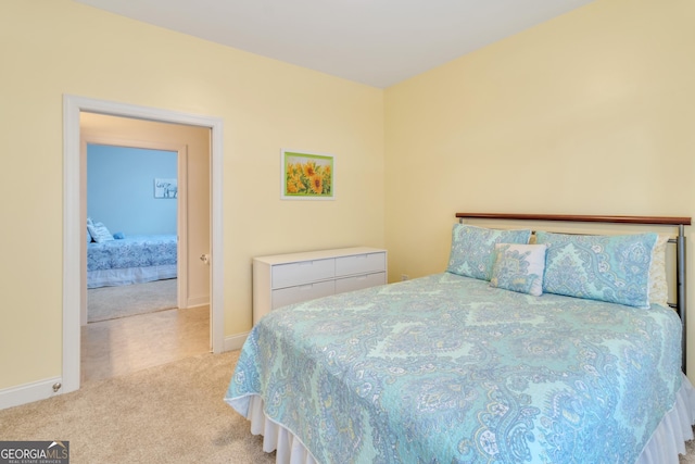 bedroom featuring baseboards and light colored carpet