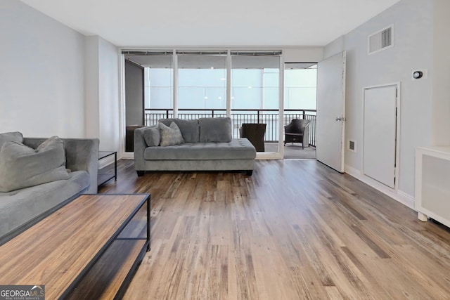 620 Peachtree St Unit 503, Atlanta, GA 30308 - living area with wood finished floors, visible vents, and baseboards