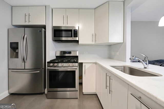 620 Peachtree St Unit 503, Atlanta, GA 30308 - kitchen featuring stainless steel appliances, light stone counters, and a sink