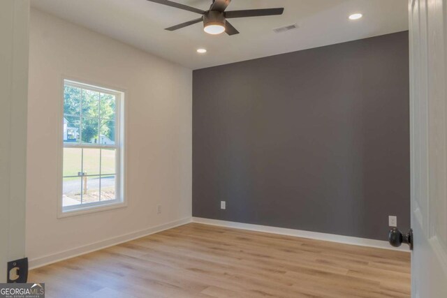 empty room featuring recessed lighting, a ceiling fan, visible vents, baseboards, and light wood finished floors