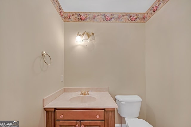 bathroom with toilet and vanity