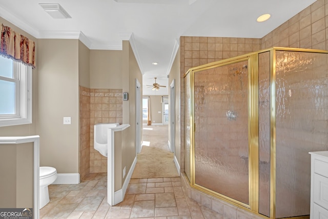 bathroom featuring toilet, ornamental molding, a stall shower, and visible vents