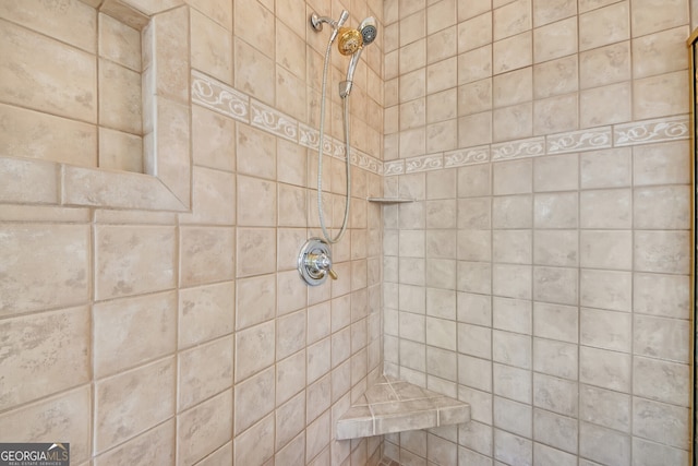 interior details featuring a tile shower