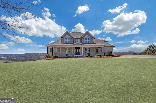 country-style home with a porch and a front yard