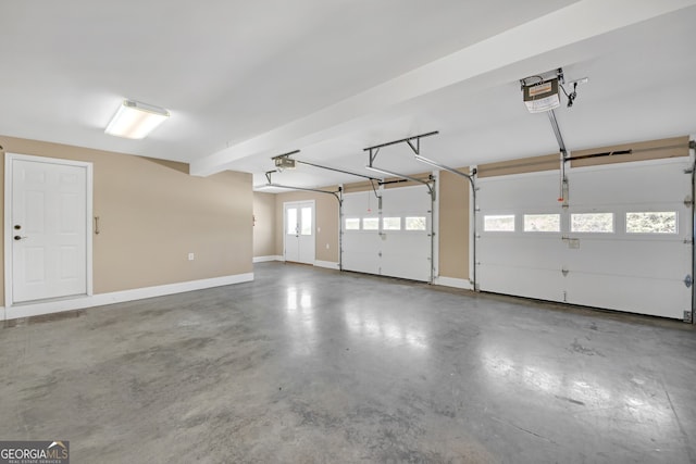 garage with a garage door opener and baseboards