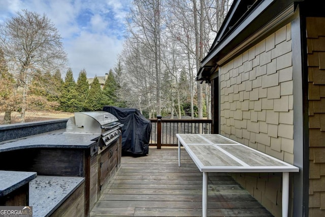 wooden terrace featuring a grill