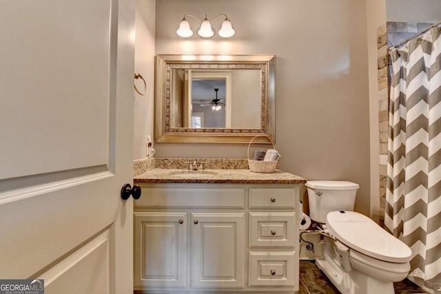 bathroom with a shower with shower curtain, vanity, and toilet