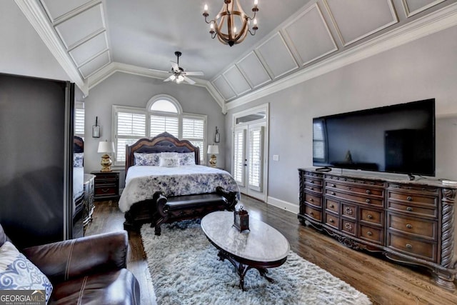 bedroom featuring crown molding, lofted ceiling, wood finished floors, baseboards, and ceiling fan with notable chandelier