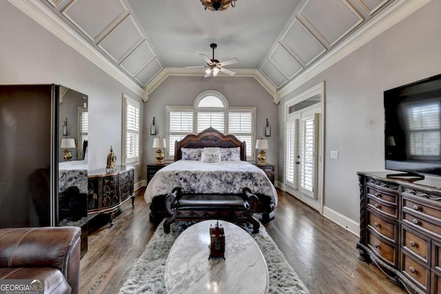 bedroom with ornamental molding, lofted ceiling, baseboards, and wood finished floors