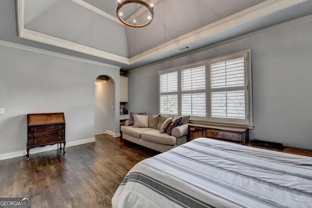 bedroom with baseboards, visible vents, arched walkways, dark wood finished floors, and crown molding