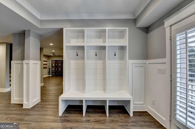 mudroom with dark wood finished floors and baseboards