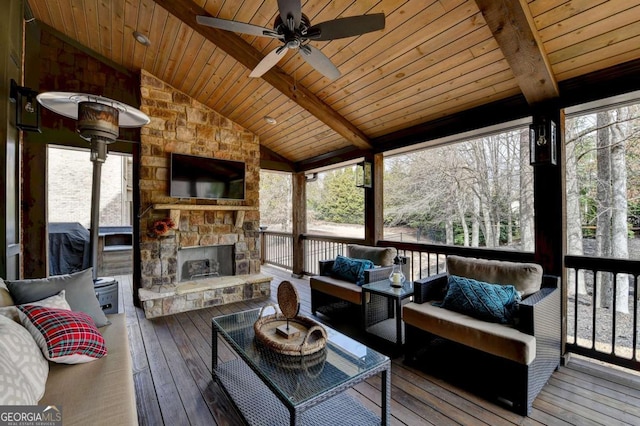 deck featuring an outdoor living space with a fireplace and a ceiling fan