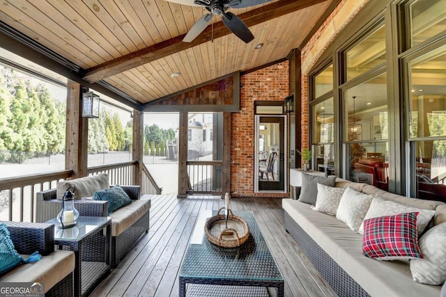 sunroom / solarium featuring lofted ceiling with beams, ceiling fan, and wood ceiling