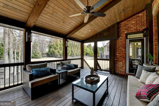 sunroom with a ceiling fan, wood ceiling, and vaulted ceiling with beams