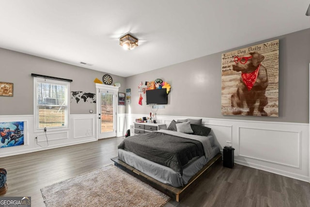 8718 Shade Tree Ct, Clermont, GA 30527 - bedroom with access to outside, dark wood-style flooring, a wainscoted wall, and a decorative wall