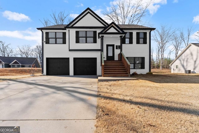 bi-level home featuring concrete driveway and an attached garage