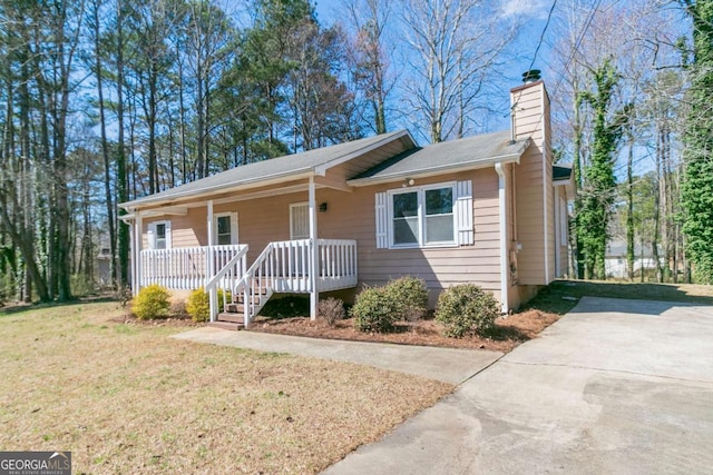 37 Indian Hills Ct, Dallas, GA 30157 - view of front facade with a porch, a chimney, a front yard, and concrete driveway
