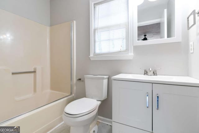 bathroom featuring toilet, bath / shower combo with glass door, a ceiling fan, and vanity