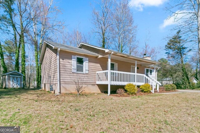 37 Indian Hills Ct, Dallas, GA 30157 - ranch-style house with a porch, a storage shed, a front yard, and a chimney