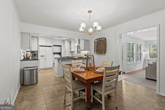 dining area featuring a chandelier, light tile patterned floors, visible vents, baseboards, and ornamental molding