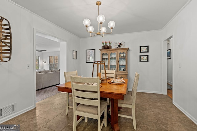 dining area featuring a chandelier, visible vents, crown molding, and baseboards