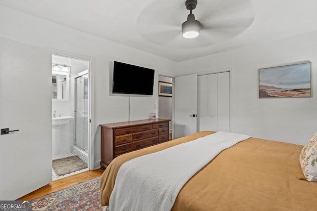 bedroom with ceiling fan, a closet, wood finished floors, and ensuite bathroom