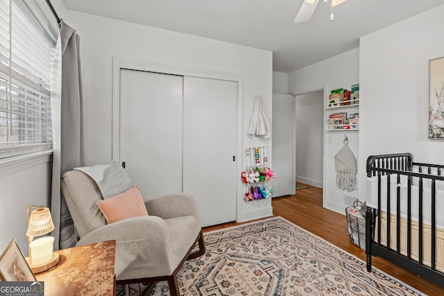 bedroom featuring a closet, wood finished floors, and a ceiling fan